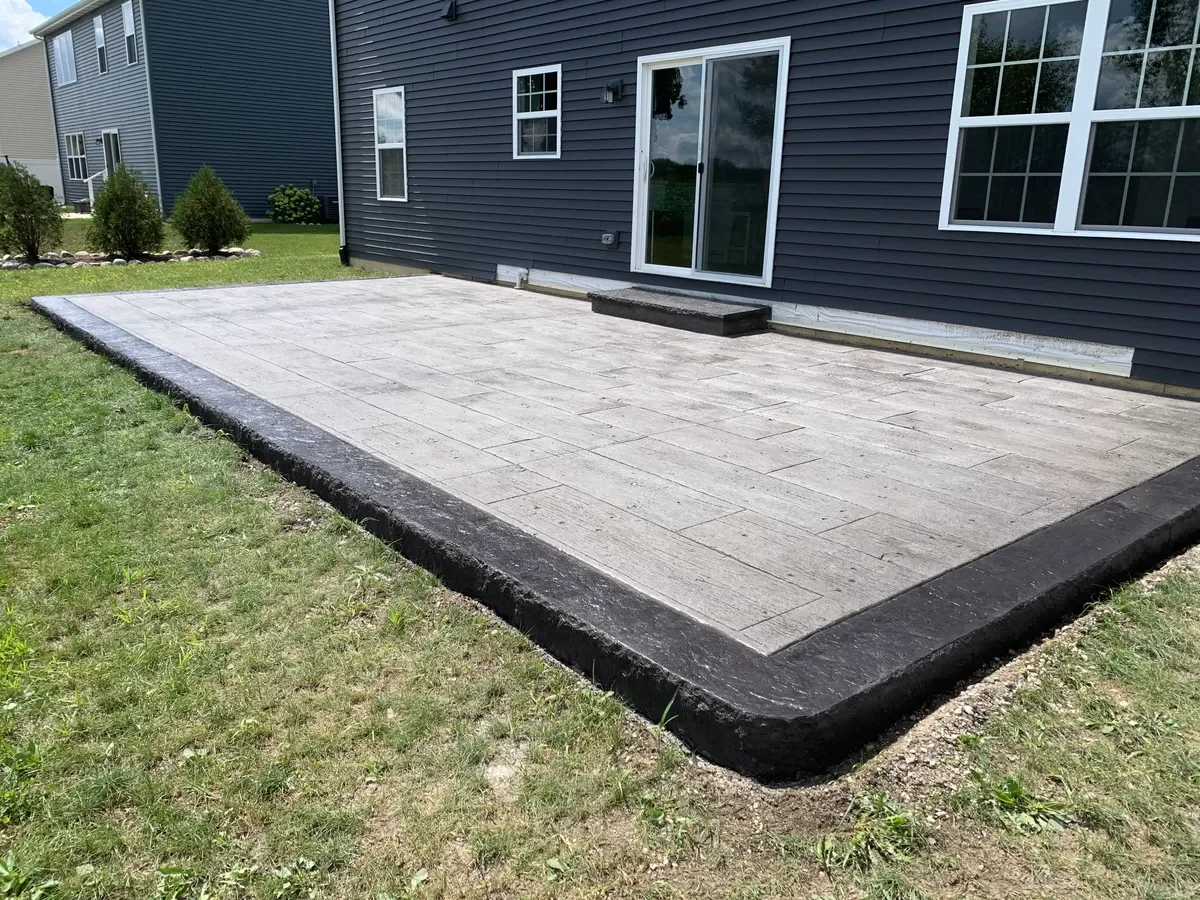 Stamped patio steps with stone accent wall