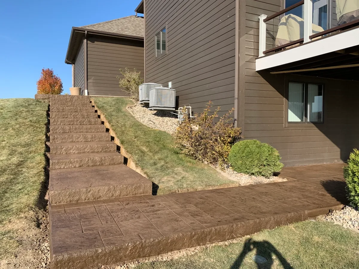 Stamped patio with retaining wall and steps