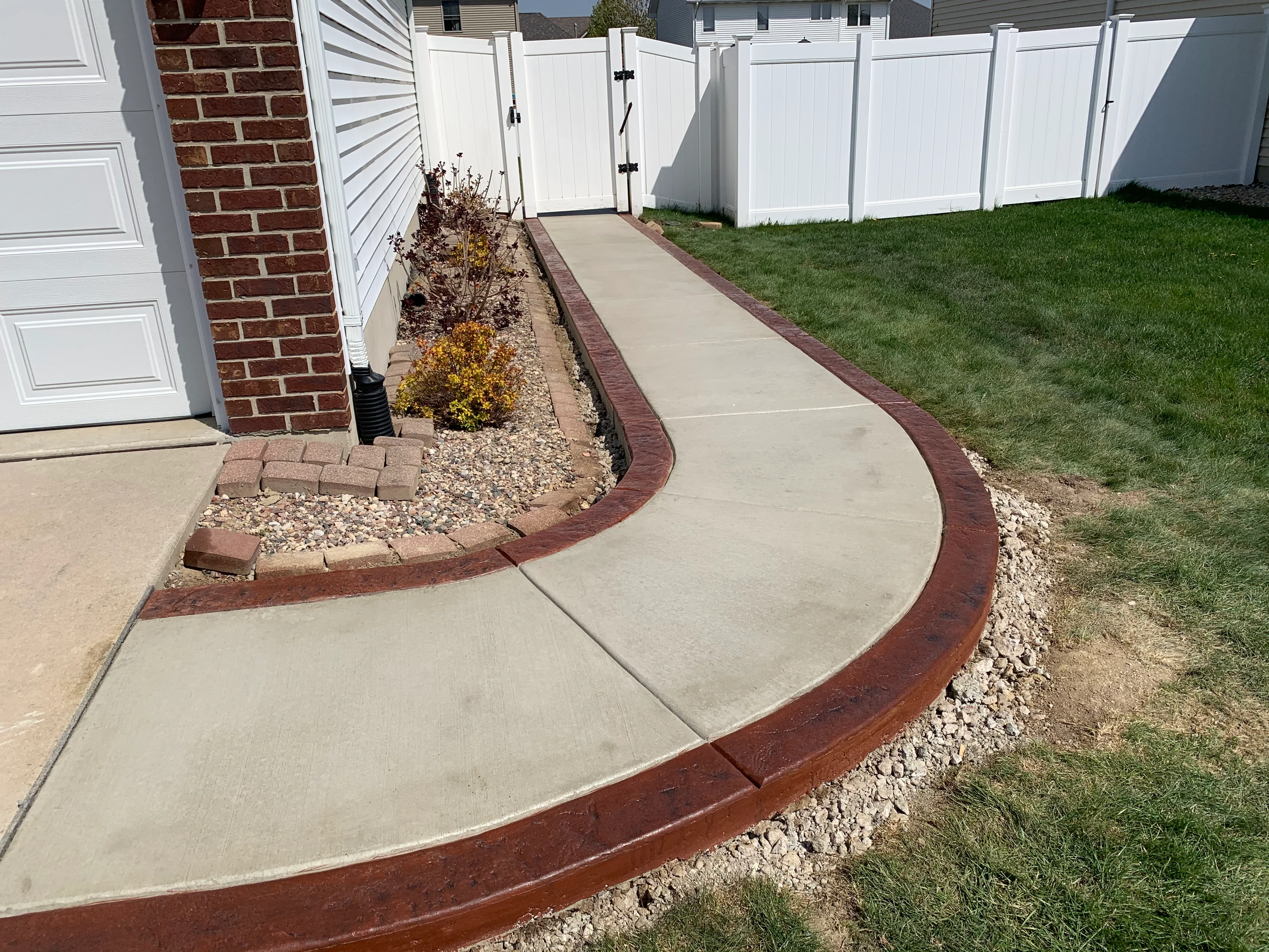Stamped concrete walkway connecting patio to home in Northwest Indiana