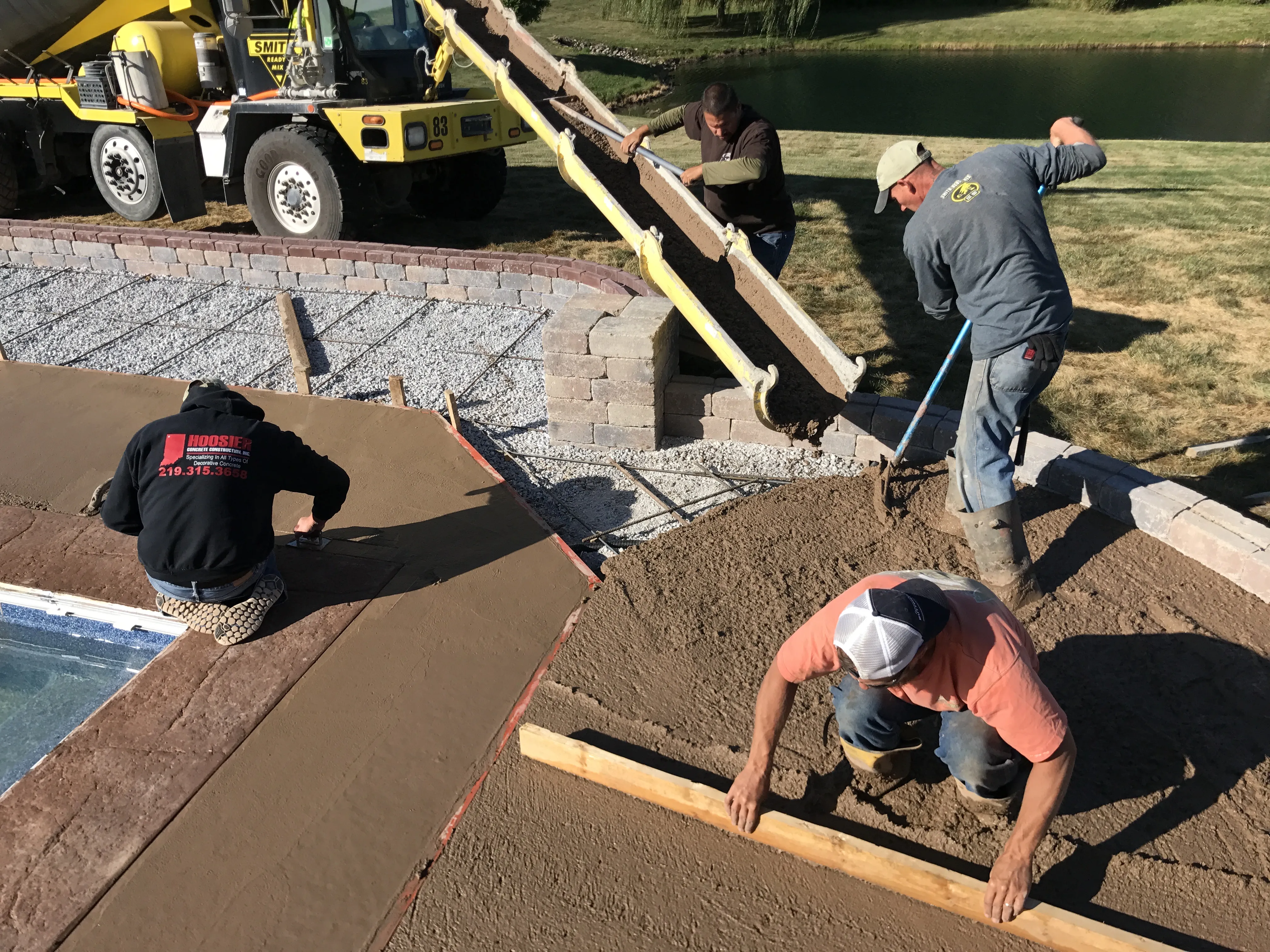 Hoosier Concrete Construction crew pouring and finishing a concrete pool deck in Northwest Indiana