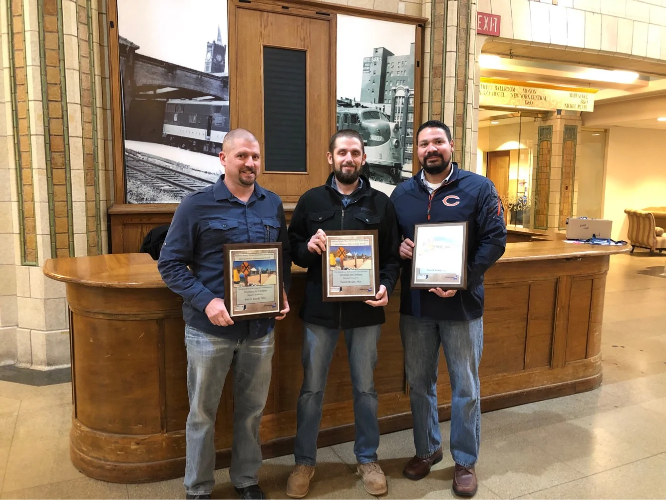 Michael Simko with award plaques for outstanding concrete craftsmanship